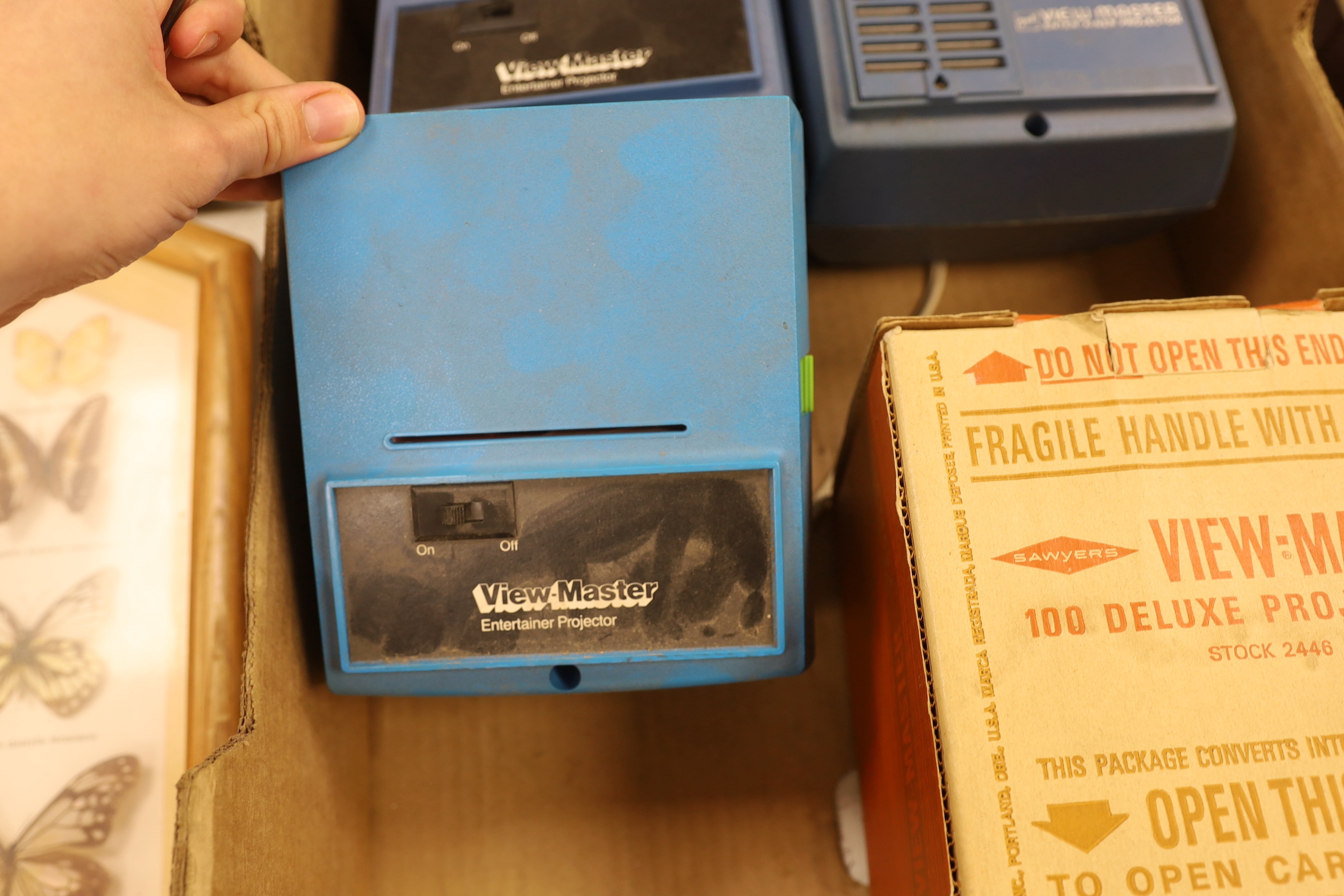 A View-Master metal Standard Projector and three Junior Projectors
